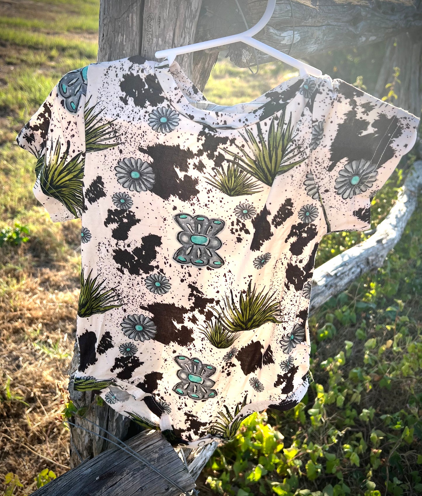 COWHIDE & CONCHO ONESIE